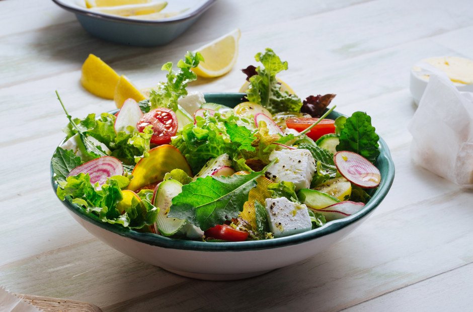 A bowl of green salad with feta
